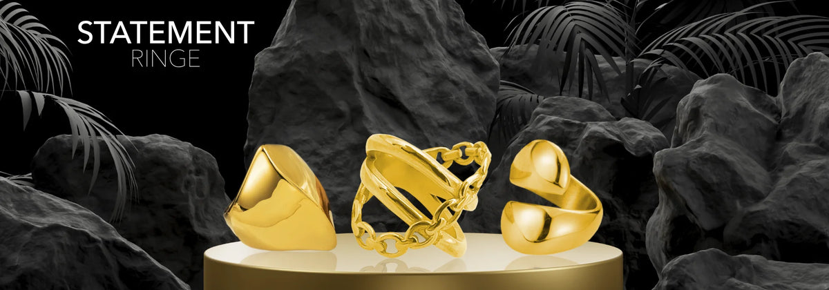 Goldene Statement Ringe auf dunklem Podest – Statement Ringe Kollektion bei Sucre Fine Jewelry