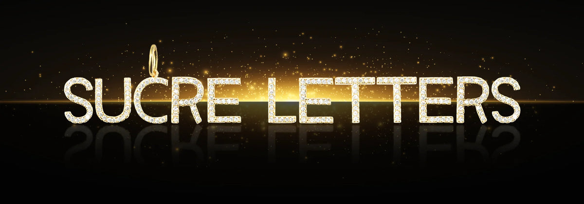 Goldene Buchstaben-Anhänger mit Zirkonia auf schwarzem Hintergrund – Sucre Letters Kollektion bei Sucre Fine Jewelry